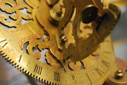 closeup of an old golden sundial