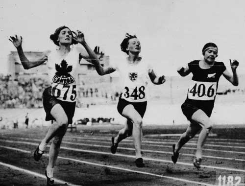 Myrtle Cook of Canada (left) winning a preliminary heat in the women's 100 metres race at the VIIIth Summer Olympic Games
