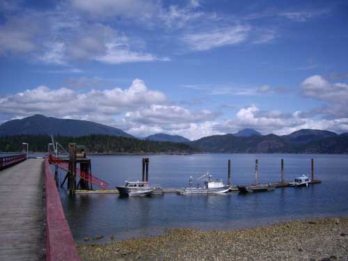 Preparing for the simple life on Cortes Island, B.C. A dock on the ocean with mountains in the distance.