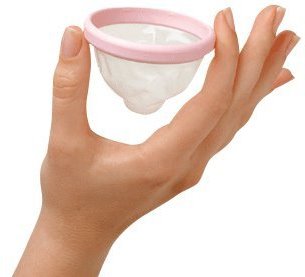 A woman's hand delicately holds a flexible pink plastic cup between her index and forefinger.