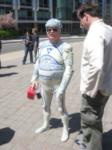 Older heavyset man in a cosplay Tron costume.