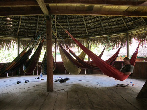 Several hammocks in a palm roof hut; the original space saving furniture.