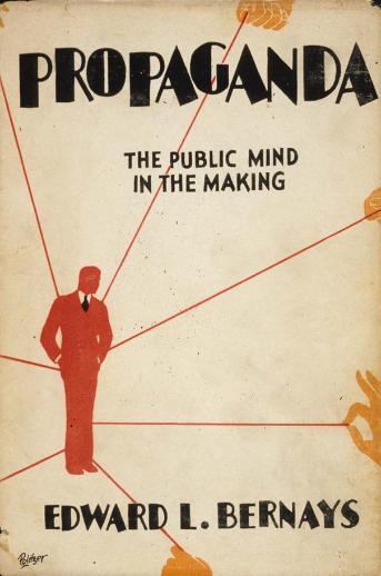 1928 book cover, "Propaganda the public mind in the making"with a distant hand pulling strings on a red silhouette of a man.