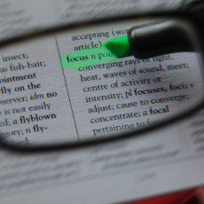 Minimalism is a focusing tool just like reading glasses; shown here highlighting the word "focus" in a book.