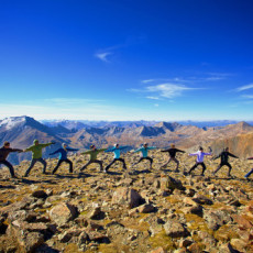 14 people doing yoga on top of a mountain in Boulder, Colorado, USA