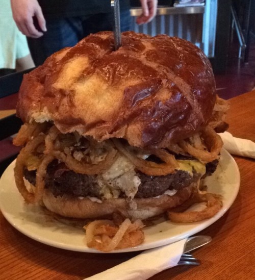 The Grim Reaper is a 4lb beef burger, 1lb of bacon, 6 fried eggs, onion rings with chili cheese tater tots on a giant bun.